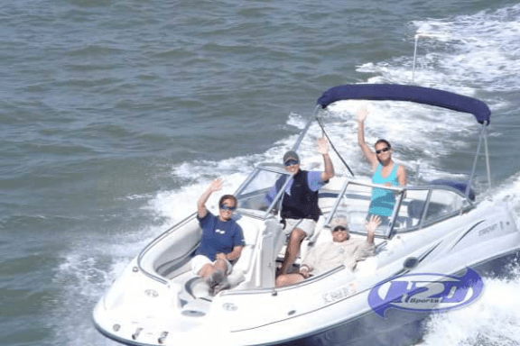 a group of people in a small boat in a body of water