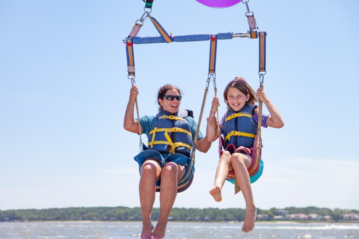 a person standing next to a body of water