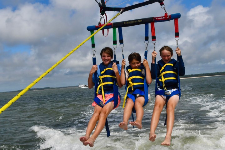 a person holding a kite in a boat on the water