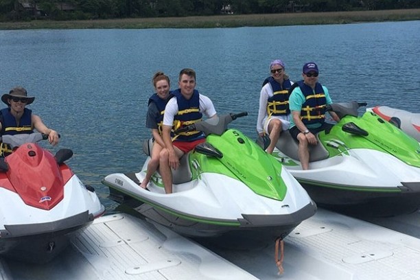 a group of people in a small boat in a body of water