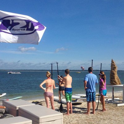 a group of people in a boat on the beach