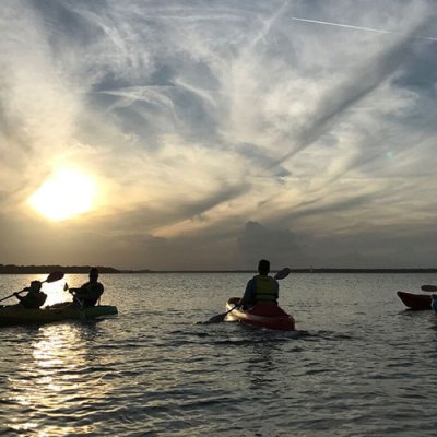 a group of people in a small boat in a body of water