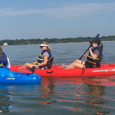 a group of people in a small boat in a body of water