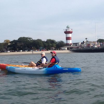 a person riding on the back of a boat in the water