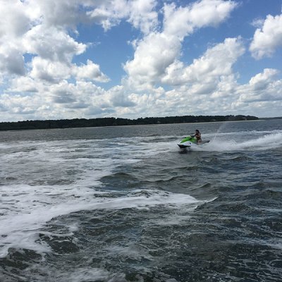a man riding a wave on top of a body of water