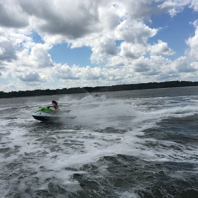 a man riding a wave on top of a body of water