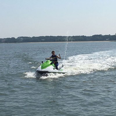 a man riding a wave on top of a body of water