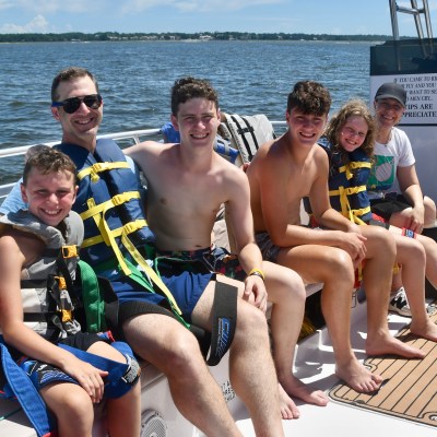 Philip Wiegratz et al. sitting on a boat in the water